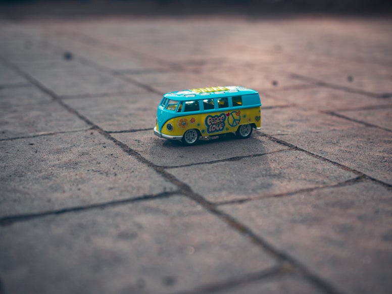A little toy bus on the pavement