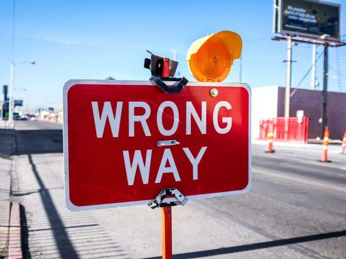 Red Wrong Way sign, Photo by NeONBRAND on Unsplash