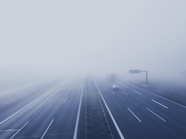 A highway disappearing in the fog. Credits: Pexels / Markus Spiske