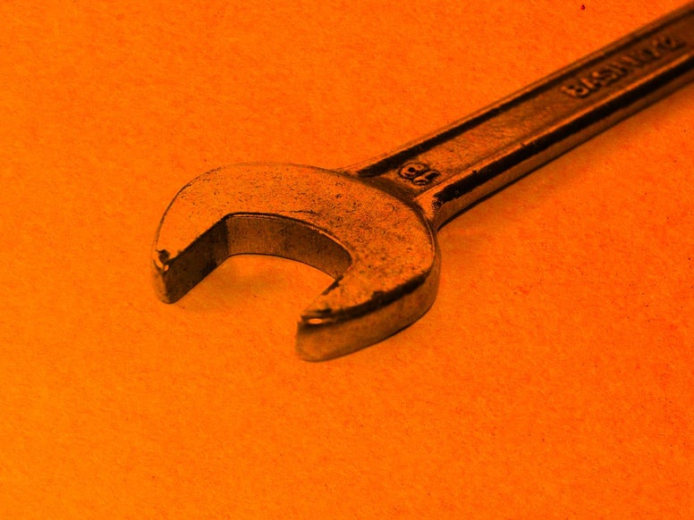 A wrench on an orange background